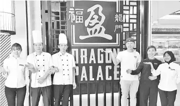  ??  ?? Jake (third right) and his staff introducin­g the restaurant which is located on the 1st Floor of Suria Sabah.