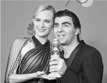  ??  ?? Actress Diane Kruger and director/producer Fatih Akin pose with his award for Best Motion Picture - Foreign Language for ‘In the Fade’ at the 75th Golden Globe Awards in Beverly Hills, California, US Jan 7. — Reuters photo