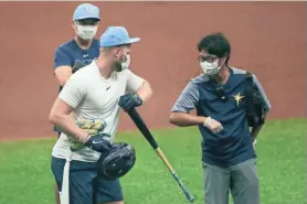  ?? ASSOCIATED PRESS ?? Tampa Bay put star outfielder Austin Meadows, left, on the injured list Thursday night after he tested positive for COVID-19.