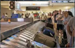  ?? RICK KAUFFMAN — DIGITAL FIRST MEDIA ?? Travelers from Orlando, Fla., await their baggage Friday at Philadelph­ia Internatio­nal Airport, a destinatio­n for many who fled approachin­g Hurricane Irma.