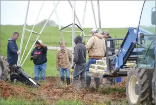  ?? TIMES photograph by Annette Beard ?? Crowder Constructi­on employees work to prepare a solid foundation for the old windmill Friday, May 6.