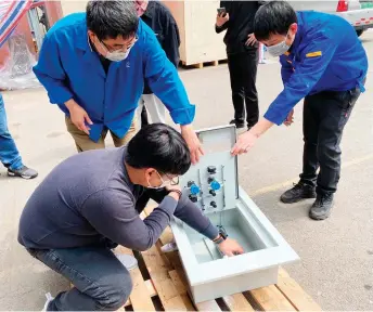  ?? ?? Engineers and technician­s conduct a thorough inspection of a local control panel following the completion of a dust resistance test.