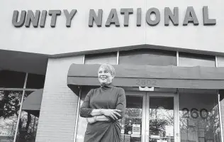  ?? Karen Warren / Staff photograph­er ?? Unity National Bank President Laurie Vignaud stands outside the bank’s Third Ward location at 2602 Blodgett St. Unity also has another location in Missouri City and a branch in Atlanta.