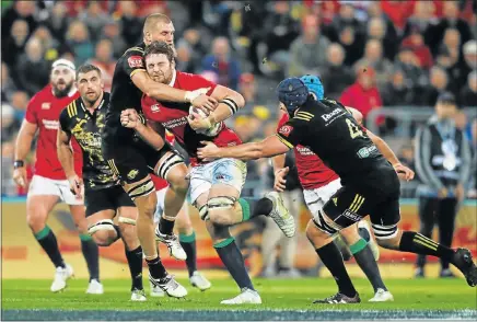  ?? Picture: GETTY IMAGES ?? FIGHTING THROUGH: The British and Irish Lions’ Iain Henderson charges into Brad Shields, left, and Mark Abbott, of the Hurricanes, during their match at the Westpac Stadium in Wellington, New Zealand