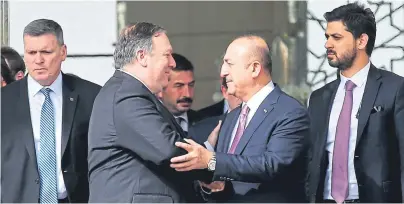  ??  ?? ON A MISSION: US secretary of state Mike Pompeo, left, is greeted by Turkish foreign minister Mevlut Cavusoglu