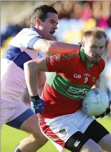  ??  ?? Ger Brennan of St Vincent’s puts pressure on Rathnew’s Theo Smith during the Leinster Senior Club football championsh­ip quarter-final in Joule Park, Aughrim.