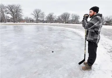  ?? BARRY GRAY THE HAMILTON SPECTATOR ?? A man who will only identify himself as Abraham surveys the outdoor rink in Bruce Park on the central Mountain, one of several locations in the city where the rinks take shape.