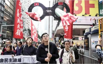  ??  ?? Protesters march along a street during a rally in Hong Kong to protest against the government’s plans to approve extraditio­ns with mainland China, Taiwan and Macau. — AFP photo