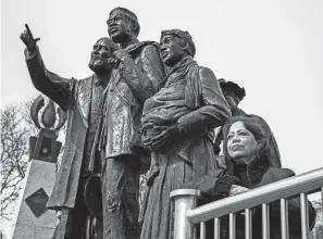  ?? DAVID RODRIGUEZ MUNOZ/DETROIT FREE PRESS ?? Kimberly Simmons, executive director and president of the Detroit River Project, stands next to the Internatio­nal Memorial to the Undergroun­d Railroad in Detroit on Thursday.