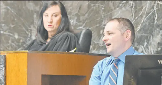  ?? Daniel Mears The Associated Press ?? Oxford High School counselor Shawn Hopkins, with Oakland County Judge Cheryl Matthews looking on, testifies at the James Crumbley trial in Pontiac, Mich., on Monday. Crumbley is on trial for involuntar­y manslaught­er in his son’s killing of four students.