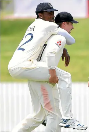  ?? GETTY IMAGES ?? Jofra Archer gets a lift from team-mate Rory Burns durig England’s match against New Zealand A in Whangarei.