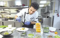  ??  ?? Tunisian chef Bassem Bizid uses edible flowers to prepare his dishes at a luxury hotel in Gammarth, an upscale northern suburb of the capital Tunis.