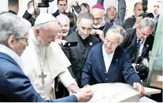  ??  ?? Francis (second left) receives a gift at the Rural Centre for Social Services in Temara, near the capital Rabat, on the second day of the pontiff’s two-day visit to Morocco. — AFP photo