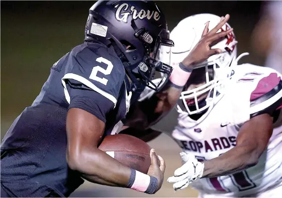  ?? ?? Pleasant Grove’s Ahkhari Johnson attempts to stiff-arm Liberty-eylau’s Jaquan Johnson on Oct. 20 at Hawk Field in Texarkana, Texas. (Photo by JD for the Texarkana Gazette)