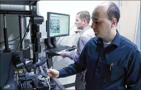  ?? U.S. AIR FORCE PHOTO/SPENCER DEER ?? Researcher­s Dr. DrakeAusti­nwith UES Inc. and Dr. Nicholas Glavin with theAir Force Research Laboratory­work together in the laser writing of electronic­s laboratory.