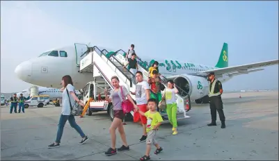  ?? PROVIDED TO CHINA DAILY ?? Passengers alight a plane of Spring Airlines after it lands in Dalian, Liaoning province, in 2016.