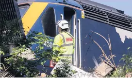  ??  ?? Clouds emerged from stricken train after it careered off tracks, and above, rescue teams arrive at the scene of the derailment