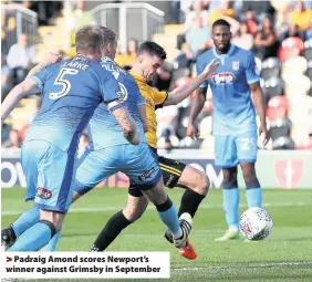  ??  ?? > Padraig Amond scores Newport’s winner against Grimsby in September