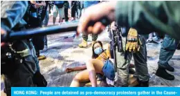  ??  ?? HONG KONG: People are detained as pro-democracy protesters gather in the Causeway Bay district of Hong Kong. — AFP