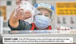  ?? AP ?? FRONT LINE: The UFCW grocery union and Kroger are starting to take different sides over issues surroundin­g workers’ pandemic-tied risks.