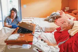  ?? Shafkat Anowar/Dallas Morning News ?? Angela Blankenshi­p works as a personal care attendant for Rick Frame, who is paralyzed from the neck down, allowing him to stay in his home in Arlington.