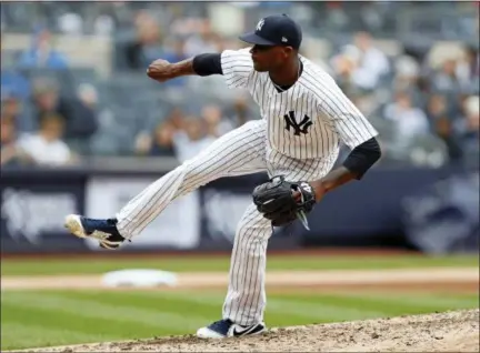  ?? KATHY WILLENS — THE ASSOCIATED PRESS ?? New York Yankees starting pitcher Domingo German (65) follows through on a pitch during the sixth inning of a baseball game against the Cleveland Indians in New York, Sunday. German pitched a no-hitter through six innings in his debut as a starting...