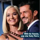  ??  ?? With his fiancée, pop star Katy Perry