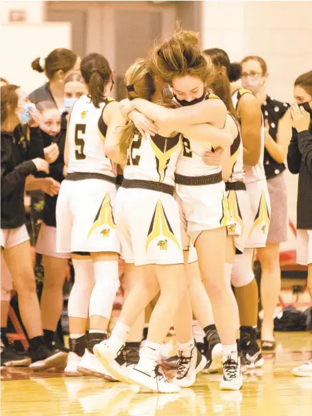  ?? RICH HUNDLEY III / SPECIAL TO THE MORNING CALL ?? Northweste­rn Lehigh players embrace after defeating Palmerton in Friday night’s Colonial League girls championsh­ip game at Moravian Academy in Bethlehem Township.