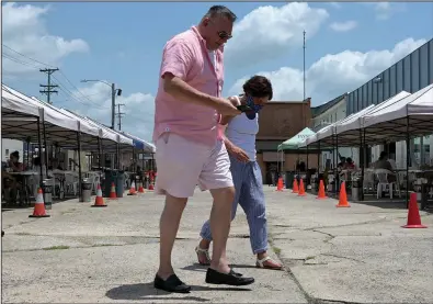  ?? (Arkansas Democrat-Gazette / Stephen Swofford) ?? Terry Gibson and Flara Hobbs are shown Saturday at Flyway Brewing in North Little Rock. A proposed mask ordinance will be presented to the City Council today.