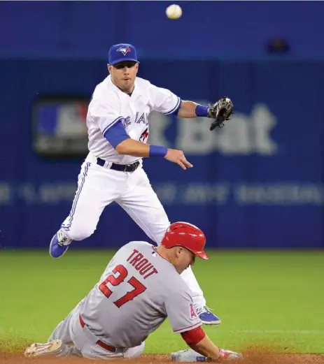  ?? FRANK GUNN/THE CANADIAN PRESS ?? Blue Jays’ Steve Tolleson fires to first for the double play as the Angels’ Mike Trout is forced out at second Tuesday night at the Rogers Centre.