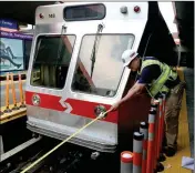  ?? NATIONAL TRANSPORTA­TION SAFETY BOARD VIA AP ?? IN THIS PHOTO RELEASED VIA TWITTER by the National Transporta­tion Safety Board, NTSB investigat­or Rick Downs takes measuremen­ts at scene of a commuter rail accident Tuesday, Aug. 22, 2017, in Upper Darby, Pa. An inbound train crashed into the rear of...