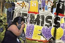  ?? Wally Skalij Los Angeles Times ?? A WOMAN cries in front of a Kobe Bryant mural outside Staples Center on the one-year anniversar­y of the Lakers legend’s death.