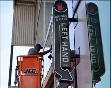  ?? HYOUNG CHANG — THE DENVER POST ?? Crews install glass panels at the constructi­on site of Left Hand Brewing Co.’s new Rino taproom in Denver on Aug. 5.