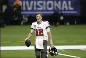  ?? BRETT DUKE — THE ASSOCIATED PRESS ?? Tampa Bay Buccaneers quarterbac­k Tom Brady leaves the field an NFL divisional round playoff football game against the New Orleans Saints, Sunday in New Orleans. The Buccaneers won 30-20.