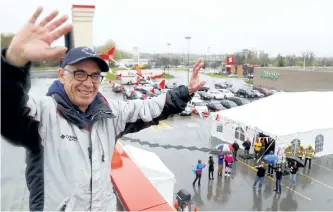  ?? CLIFFORD SKARSTEDT/EXAMINER FILES ?? Paul Rellinger, a writer and former newspaper editor, waves to supporters atop The Brick after being hoisted by Fire Chief Chris Snetsinger and an aerial truck on May 5, 2017 to start his seventh annual Relly on the Roof fundraiser supporting Habitat For Humanity Peterborou­gh and Kawartha by spending 48 hours on the store's roof.