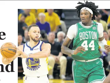  ?? AP PHOTOS ?? Golden State Warriors guard Stephen Curry (left) passes the ball in front of Boston Celtics centre Robert Williams III during the first half of Game One of basketball’s NBA Finals in San Francisco on Thursday.