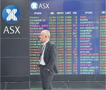  ?? EPA-EFE ?? A man stands in front of an electronic indicator board at the Australian Stock Exchange (ASX) in Sydney yesterday. The S&amp;P-ASX 200 shed 0.8% to 5,668.40.