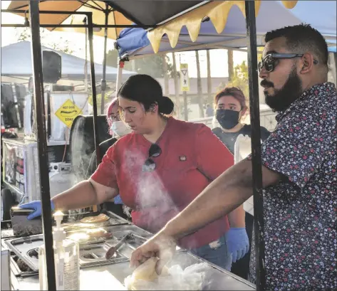  ?? CORISSA IBARRA PHOTO ?? Local vendor Jr. Tacos & Grill serves patrons Thursday during the 3rd annual Taco Festival in Brawley.
