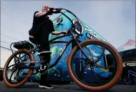  ?? LUIS SINCO — LOS ANGELES TIMES/TNS, FILE ?? Tom Bock is the owner of Pedego Electric Bikes in Huntington Beach. Southern California city officials and police are grappling with how to keep everyone safe with e-bikes.