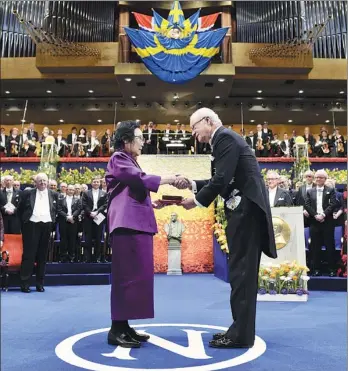  ?? JONAS EKSTROMER / REUTERS ?? Tu Youyou, winner of the 2015 Nobel Prize in Physiology or Medicine, receives her award from King Carl Gustaf of Sweden in Stockholm. Tu discovered (artemisini­n) which is now widely used to treat the tropical disease of malaria.