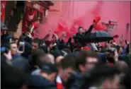  ?? THE ASSOCIATED PRESS ?? In this file photo, Liverpool supporters light red flares outside the stadium before the Champions League semifinal, first leg, soccer match between Liverpool and AS Roma at Anfield Stadium, Liverpool, England. Roma’s outspoken American president Jim...