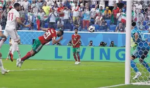  ?? THEMBA HADEBE/ASSOCIATED PRESS ?? Morocco’s Aziz Bouhaddouz (20) scores an own goal in the 95th minute of his team’s 1-0 loss to Iran.