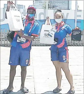  ?? ( Courtesy pic) ?? Boxer Thabiso Dlamini ( L) and swimmer Robyn Young displaying their gifts in Tokyo ahead of the Tokyo 2020 Olympic Games.