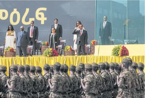  ?? AFP ?? Ethiopian leader Abiy Ahmed, first row on the right, salutes members of the defence forces during the inaugurati­on of the new government, in Addis Ababa.