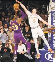  ?? Seth Wenig / Associated Press ?? The Knicks’ Mario Hezonja blocks what could have been the winning shot by the Lakers’ LeBron James during New York’s 124-123 victory on Sunday.