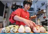  ?? ?? TOKYO: Miki Yamada, who runs ‘Warai Musubi’ a catering service for ‘omusubi’—another name for ‘onigiri’ or rice balls, prepares rice balls at her home in Tokyo.