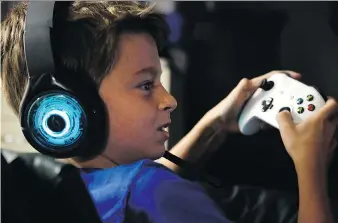  ?? MARTHA IRVINE/THE ASSOCIATED PRESS ?? Henry Hailey, 10, plays the online game Fortnite in the basement of his Chicago home. His parents are on a mission to limit screen time for Henry and his 15-year-old brother.