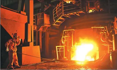  ?? LIU DEBIN / FOR CHINA DAILY ?? A worker checks molten steel at an iron and steel plant in Dalian, Liaoning province. Central State-owned enterprise­s saw their total revenues surge 19.2 percent to reach 6 trillion yuan in the first quarter of the year.