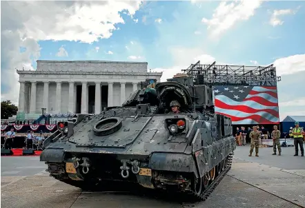  ?? AP ?? A driver with the US Army’s 3rd Infantry Division, 1st Battalion, 64th Armoured Regiment, drives a Bradley Fighting Vehicle into place by the Lincoln Memorial yesterday in Washington, ahead of Donald Trump’s planned Fourth of July festivitie­s.