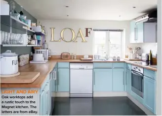  ??  ?? LIGHT AND AIRY Oak worktops add a rustic touch to the Magnet kitchen. The letters are from ebay.